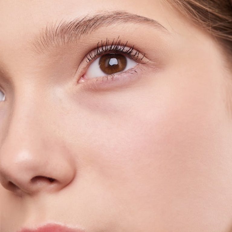 Close-up portrait capturing the natural beauty and smooth skin of a young woman.