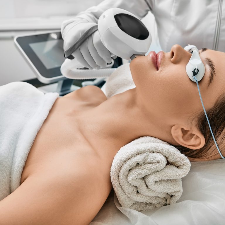 Photorejuvenation, rosacea treatment, removing brown spots and vascular mesh. Cosmetologist using