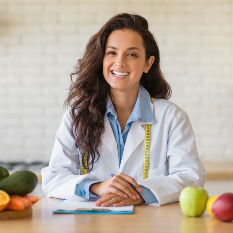 Portrait of friendly female weight loss consultant smiling at camera, recommending plant based