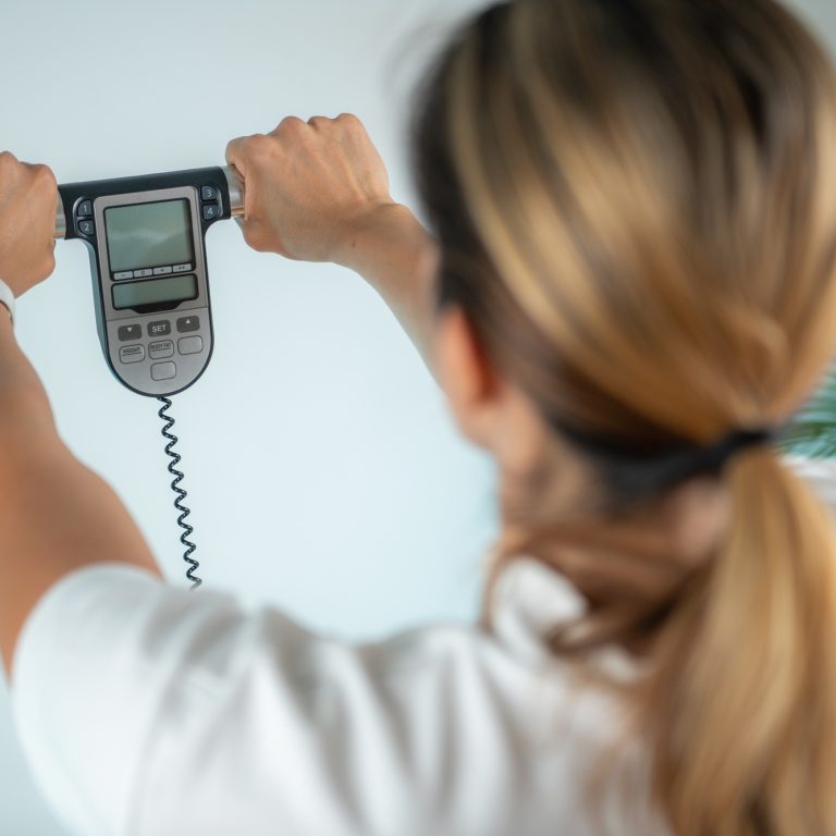 Woman using body fat scale for weight measurement.